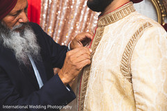 Indian groom being assisted. Indian groom being assisted.