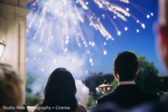 Indian couple watching the fireworks at reception party. Indian couple watching the fireworks at reception party.