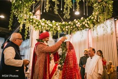 Enchanting Indian couple exchanging garlands. Enchanting Indian couple exchanging garlands.
