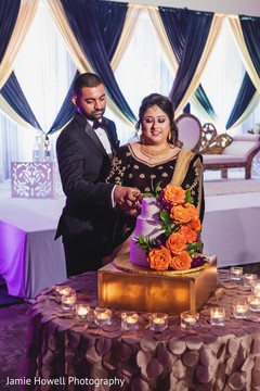 Lovely capture Indian bride and groom cutting cake together Lovely capture Indian bride and groom cutting cake together