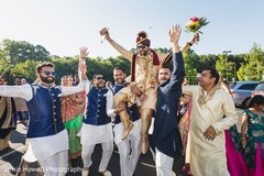 Indian groom being lifted up during baraat Indian groom being lifted up during baraat