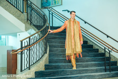 Indian groom walking down the stairs. Indian groom walking down the stairs.