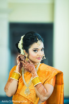 Indian bride putting earrings on. Indian bride putting earrings on.