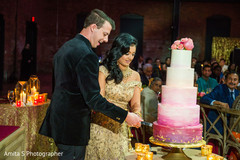 Indian couple cutting the wedding cake. Indian couple cutting the wedding cake.