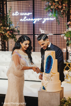 Indian bride and groom cutting the cake. Indian bride and groom cutting the cake.