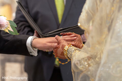 Indian bride putting wedding ring on groom Indian bride putting wedding ring on groom