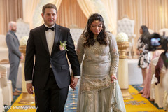 Indian bride and groom walking out from the ceremony isle Indian bride and groom walking out from the ceremony isle