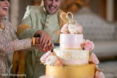 Sweet Indian couple cutting their wedding cake Sweet Indian couple cutting their wedding cake