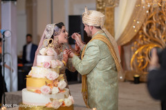Lovely capture Indian groom giving cake to the bride Lovely capture Indian groom giving cake to the bride