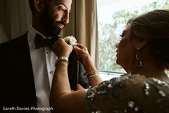 Indian groom getting his boutonniere on. Indian groom getting his boutonniere on.