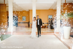 Enchanting Indian couple walking into reception. Enchanting Indian couple walking into reception.