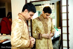 Charming Indian groom getting his sherwani on. Charming Indian groom getting his sherwani on.