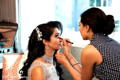 Lovely Indian bride getting her reception makeup done. Lovely Indian bride getting her reception makeup done.