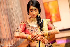 Enchanting Indian Bride fixing her bangles. Enchanting Indian Bride fixing her bangles.