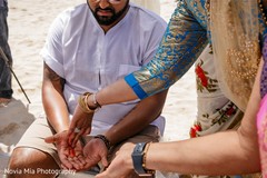 Indian groom getting red lines on his hands at Haldi. Indian groom getting red lines on his hands at Haldi.