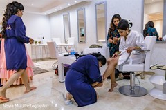 Maharani getting her anklets on. Maharani getting her anklets on.