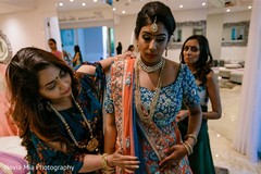 Indian bride with relatives getting ready for her big day. Indian bride with relatives getting ready for her big day.