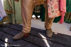 Indian groom stepping on coconut. Indian groom stepping on coconut.