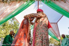 Charming Indian groom putting garland to bride. Charming Indian groom putting garland to bride.