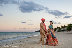 Dazzling Indian bride and groom walking holding hands. Dazzling Indian bride and groom walking holding hands.