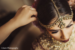 Indian bride being assisted by makeup artist. Indian bride being assisted by makeup artist.