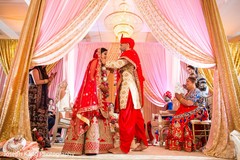 Indian groom and bride during the garland exchange. Indian groom and bride during the garland exchange.