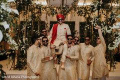 Indian groom being lifted by groomsmen. Indian groom being lifted by groomsmen.