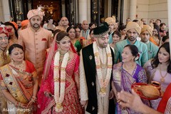 Indian bride and groom walking out the ceremony venue Indian bride and groom walking out the ceremony venue