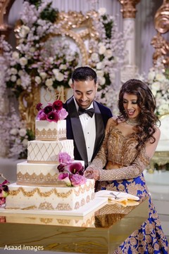 Sweet Indian bride and groom cutting cake together. Sweet Indian bride and groom cutting cake together.