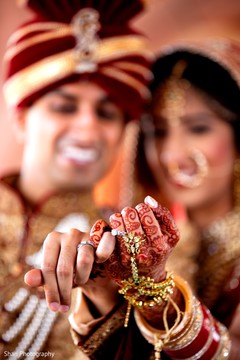 Indian couple showing their wedding rings. Indian couple showing their wedding rings.