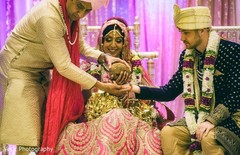 Indian bride and groom holding the coconut ritual. Indian bride and groom holding the coconut ritual.