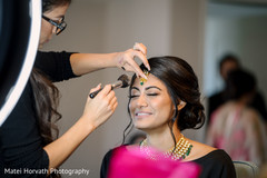 Beautiful Indian bride getting her make up done. Beautiful Indian bride getting her make up done.