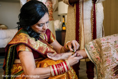 Maharani's mother putting anklet on her daughter. Maharani's mother putting anklet on her daughter.