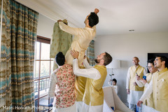 Indian groom being lifted with joy by his groomsmen. Indian groom being lifted with joy by his groomsmen.
