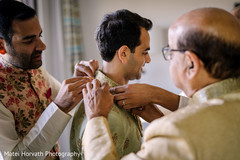 Indian groom being dressed up by his relatives. Indian groom being dressed up by his relatives.