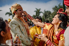 Maharani's mother pinching groom's nose. Maharani's mother pinching groom's nose.