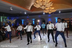 Indian groomsmen performing a choreography during the reception. Indian groomsmen performing a choreography during the reception.