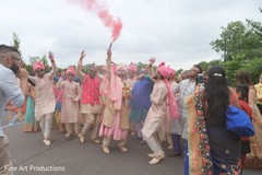 Indian groom holding a smoke torch with groomsmen during baraat. Indian groom holding a smoke torch with groomsmen during baraat.