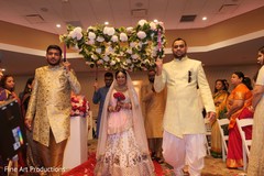 Indian bride wearing the ivory bridal saree entering to the ceremony.