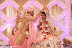 Indian bride receiving the traditional bindi. Indian bride receiving the traditional bindi.