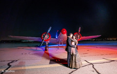 Indian couple posing in front of a light aircraft Indian couple posing in front of a light aircraft