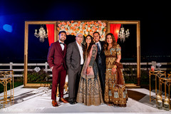 Indian couple posing with bride's family Indian couple posing with bride's family
