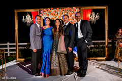 Indian bride and groom posing with groom's family Indian bride and groom posing with groom's family
