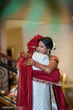 Indian bride and Raja hugging during their first look. Indian bride and Raja hugging during their first look.