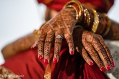 Indian bride showing her engagement ring and mehndi art. Indian bride showing her engagement ring and mehndi art.
