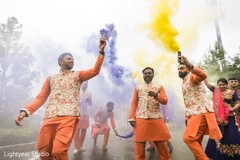 Indian groomsmen with purple and yellow smoke during Baraat. Indian groomsmen with purple and yellow smoke during Baraat.