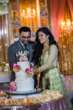 Indian bride and Raja cutting the Indian wedding cake. Indian bride and Raja cutting the Indian wedding cake.