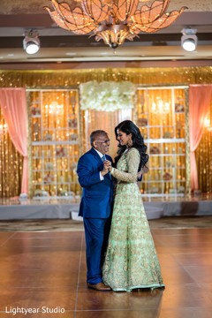 Indian bride dancing with a family member during the reception. Indian bride dancing with a family member during the reception.