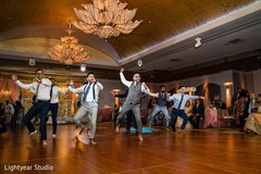 Groomsmen performing a choreography during the Indian wedding party. Groomsmen performing a choreography during the Indian wedding party.