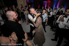 India groom kissing bride at reception party. India groom kissing bride at reception party.